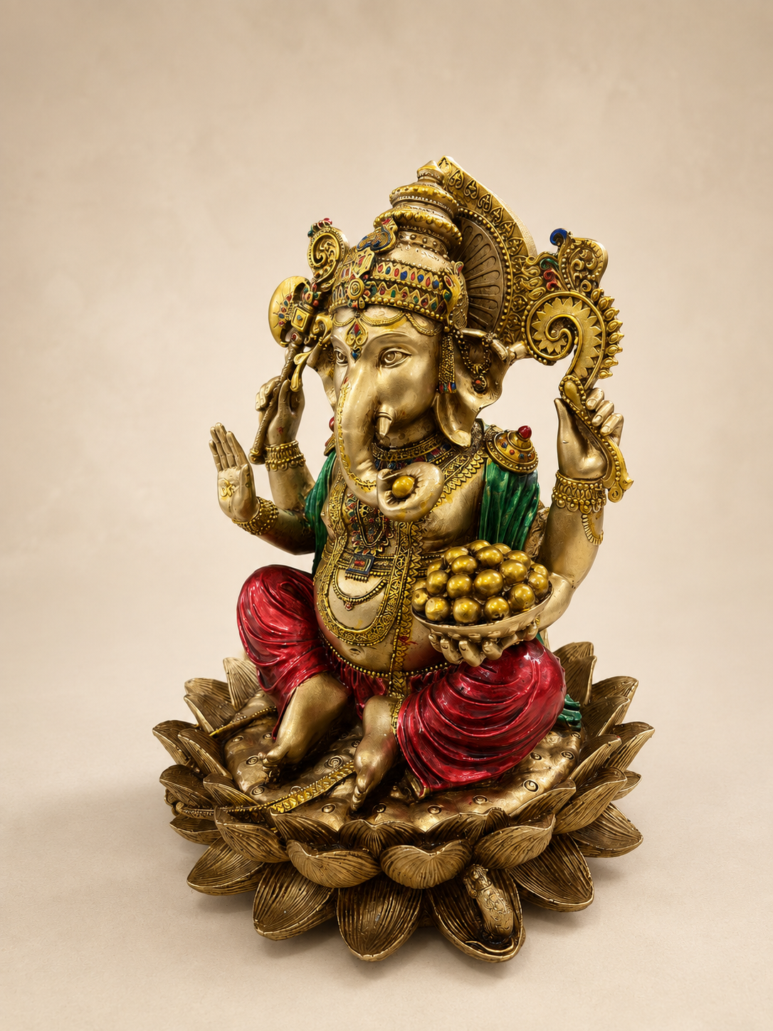 Angled view of the Ganesha idol showing the bowl of sweets, detailed jewellery and layered lotus pedestal