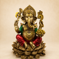 Ganesha idol seated on a layered lotus base, holding a bowl of sweets, with gold-tone finish, red dhoti and green shawl, front view