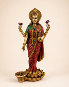 Lotus Grace Lakshmi idol with an antique gold-tone finish, red sari, lotus flowers and a coin-bowl detail, front view