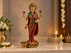 Antique gold-tone Lakshmi idol on an ivory-coloured altar with floral and diya styling