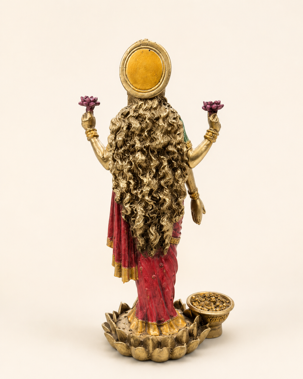 Rear view of the Lakshmi idol showing flowing hair, circular halo and lotus-style pedestal