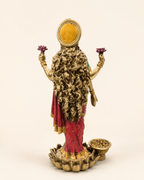 Rear view of the Lakshmi idol showing flowing hair, circular halo and lotus-style pedestal