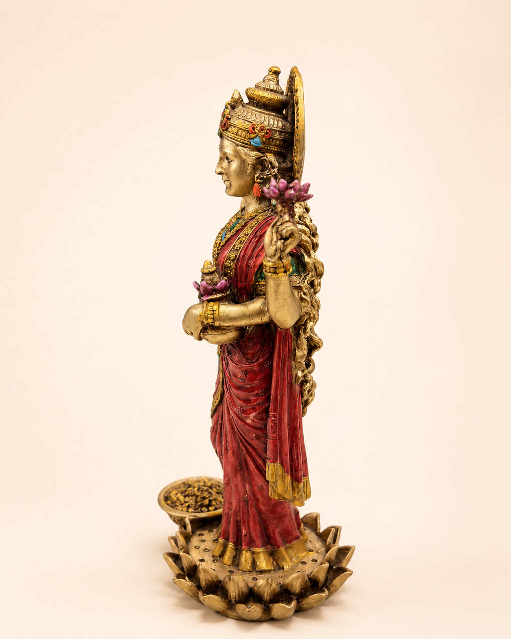 Side profile of the Lotus Grace Lakshmi idol with pink lotus flowers and ornate detailing