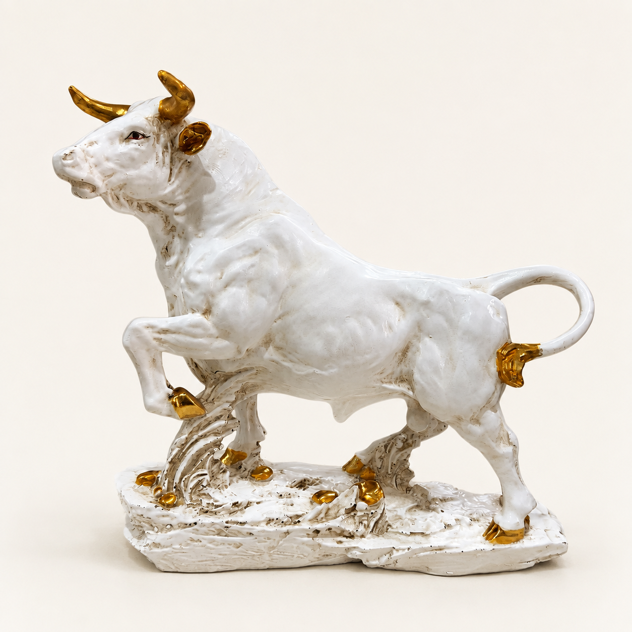 Majestic ivory and gold bull sculpture, side view