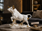 Majestic ivory and gold bull sculpture styled on a coffee table