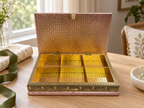 Open Mayur Darbar peacock jewellery organiser displayed beside a green ribbon and gift wrap