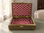 Open Mayura Bloom jewellery box with rose coloured patterned lining on a sage surface