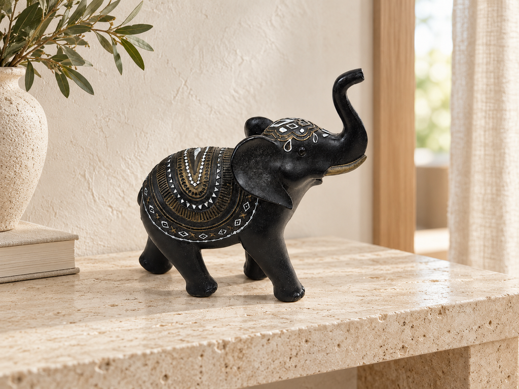 Black decorative elephant with uplifted trunk styled on a light stone console