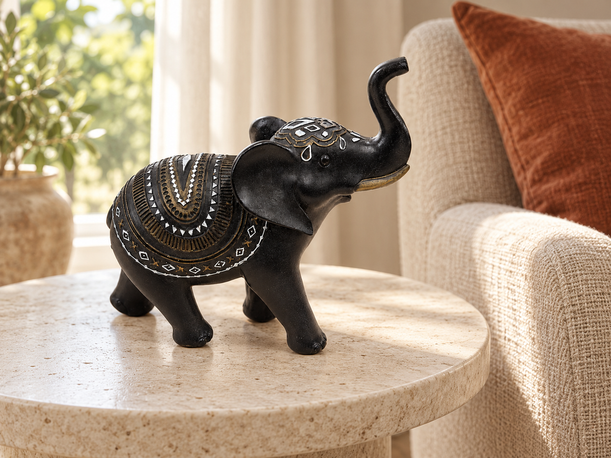 Midnight Mandala Elephant Figurine displayed on a round side table beside an armchair
