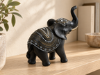 Angled rear view showing the elephant figurine's gold-tone and white patterned decoration