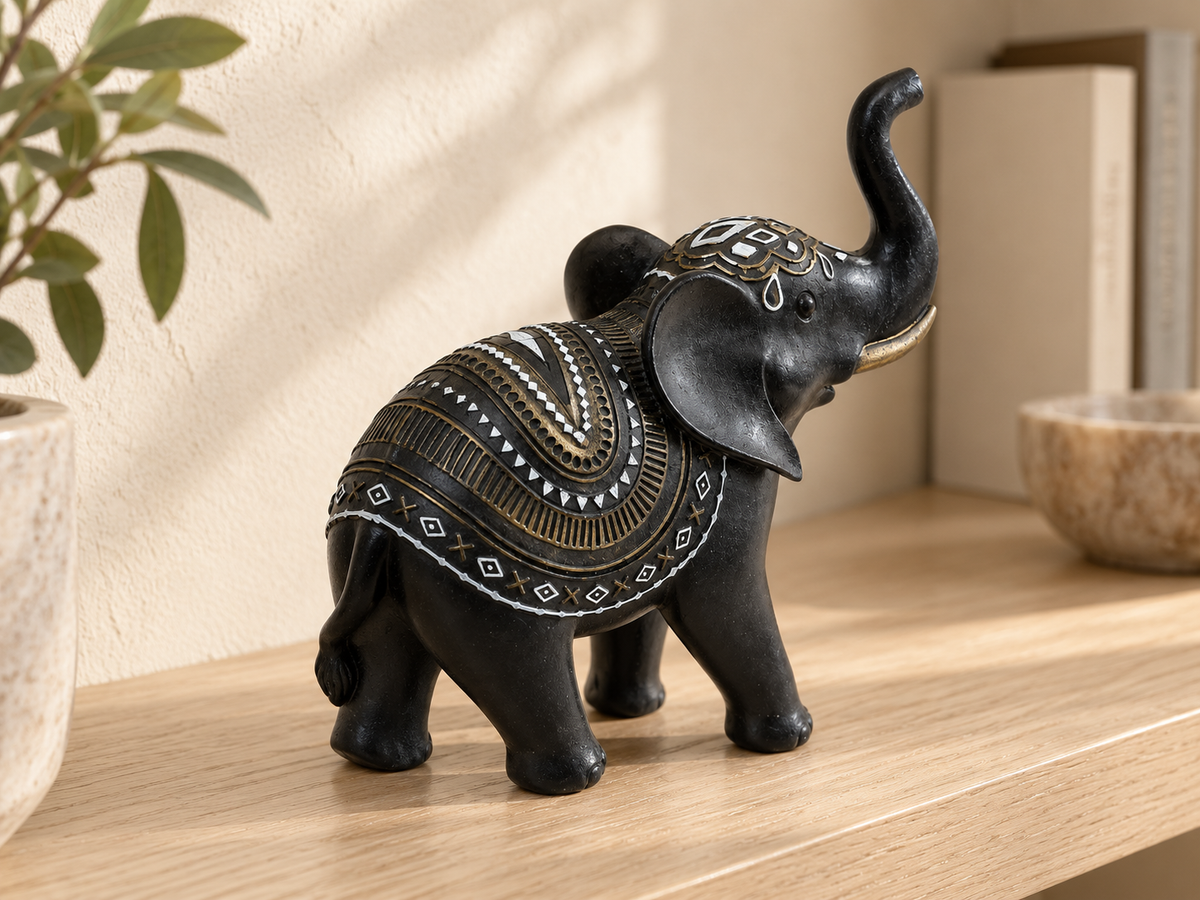 Angled rear view showing the elephant figurine's gold-tone and white patterned decoration
