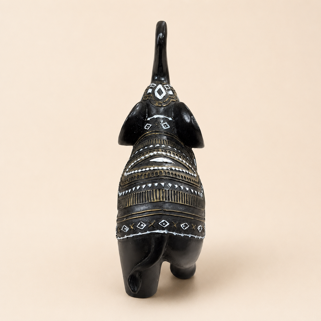 Rear view of the black elephant figurine showing ornamental bands and curved tail