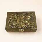 Top view of the Mor Pankh box showing raised peacock feathers, scrolling leaves and a floral medallion