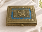 Neel Gaj elephant jewellery box displayed on ivory linen, showing its patterned blue panel and front clasp