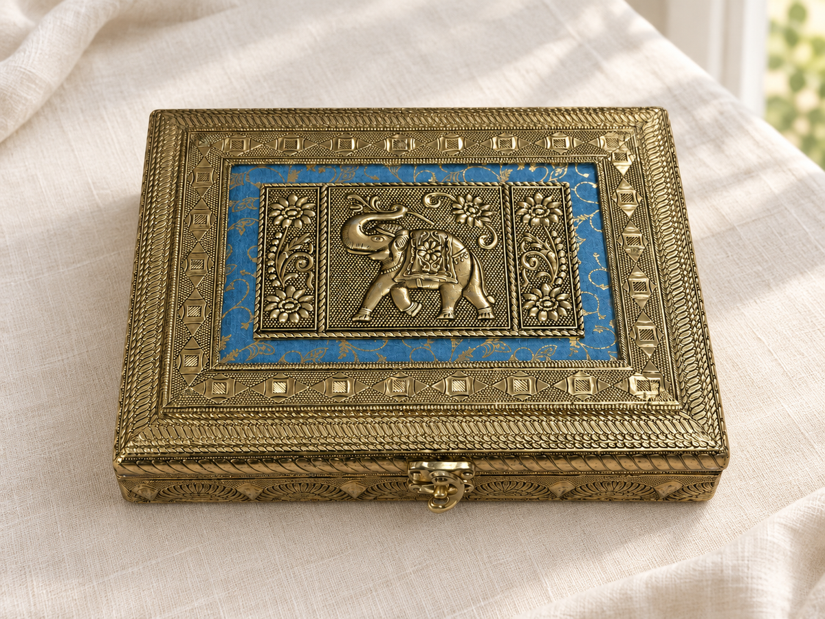 Neel Gaj elephant jewellery box displayed on ivory linen, showing its patterned blue panel and front clasp