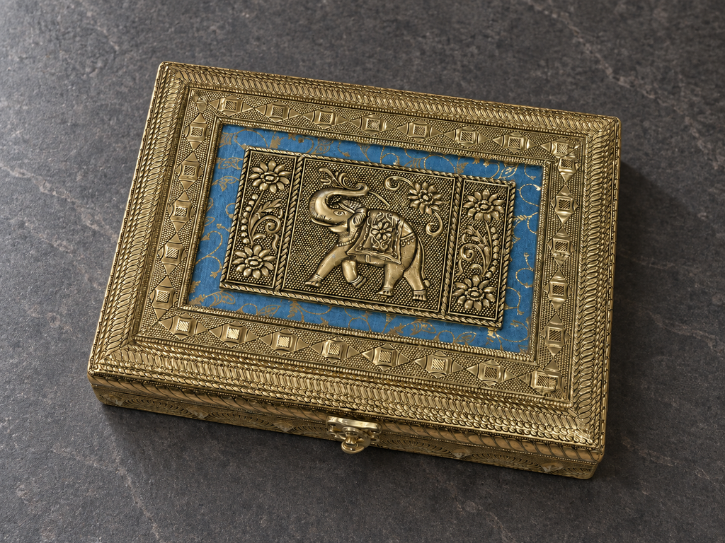 Angled detail of the elephant and floral lid panels on the Neel Gaj jewellery box on a grey stone surface