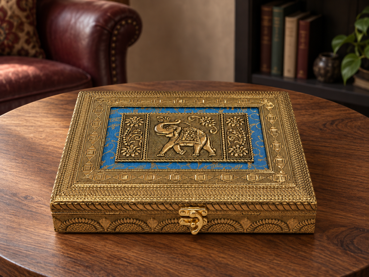 Neel Gaj blue and gold-tone elephant jewellery box displayed on a walnut table