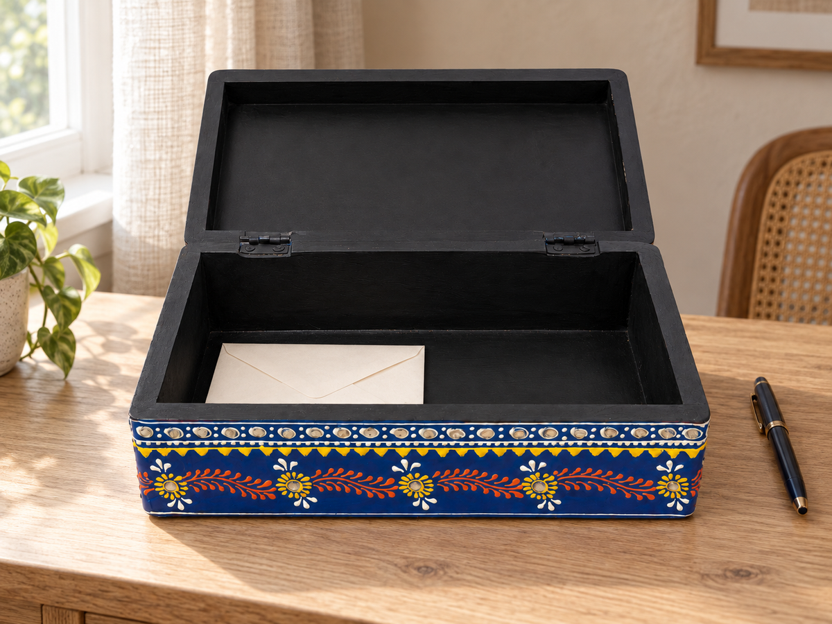 Open Neel Mandala keepsake box holding a letter on a wooden table