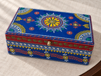 Angled view of Neel Mandala keepsake box showing the yellow floral medallion on the blue lid