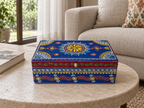 Neel Mandala blue keepsake box displayed on a stone coffee table beside a sofa