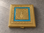 Detailed peacock lid and blue panel on the Neel Mayur square jewellery box displayed on a grey stone surface