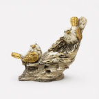 White and gold bird pair decorative sculpture on a branch, front view