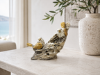 White and gold bird pair sculpture styled on a light console