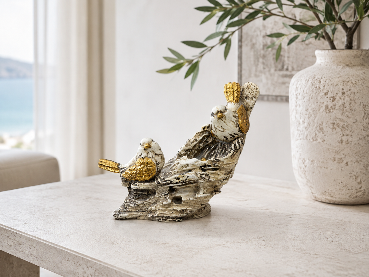 White and gold bird pair sculpture styled on a light console
