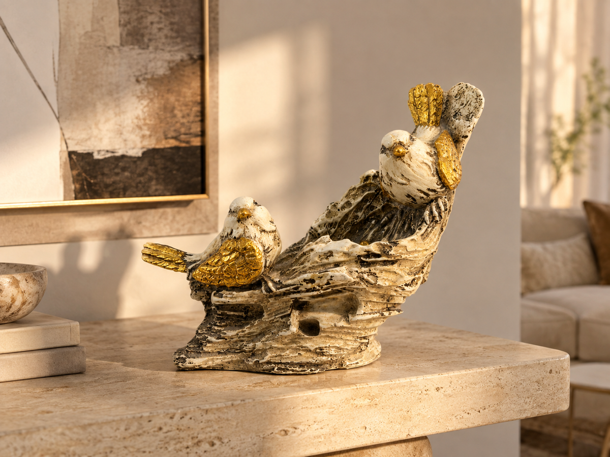 White and gold bird pair sculpture styled on a warm neutral console