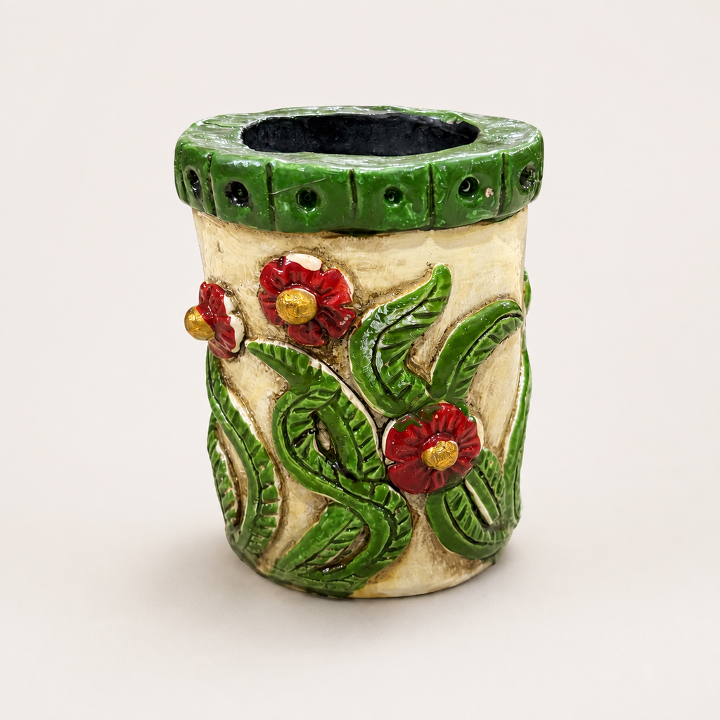 Nomad Bloom face pen stand with red flowers and green leaf detailing, alternate view