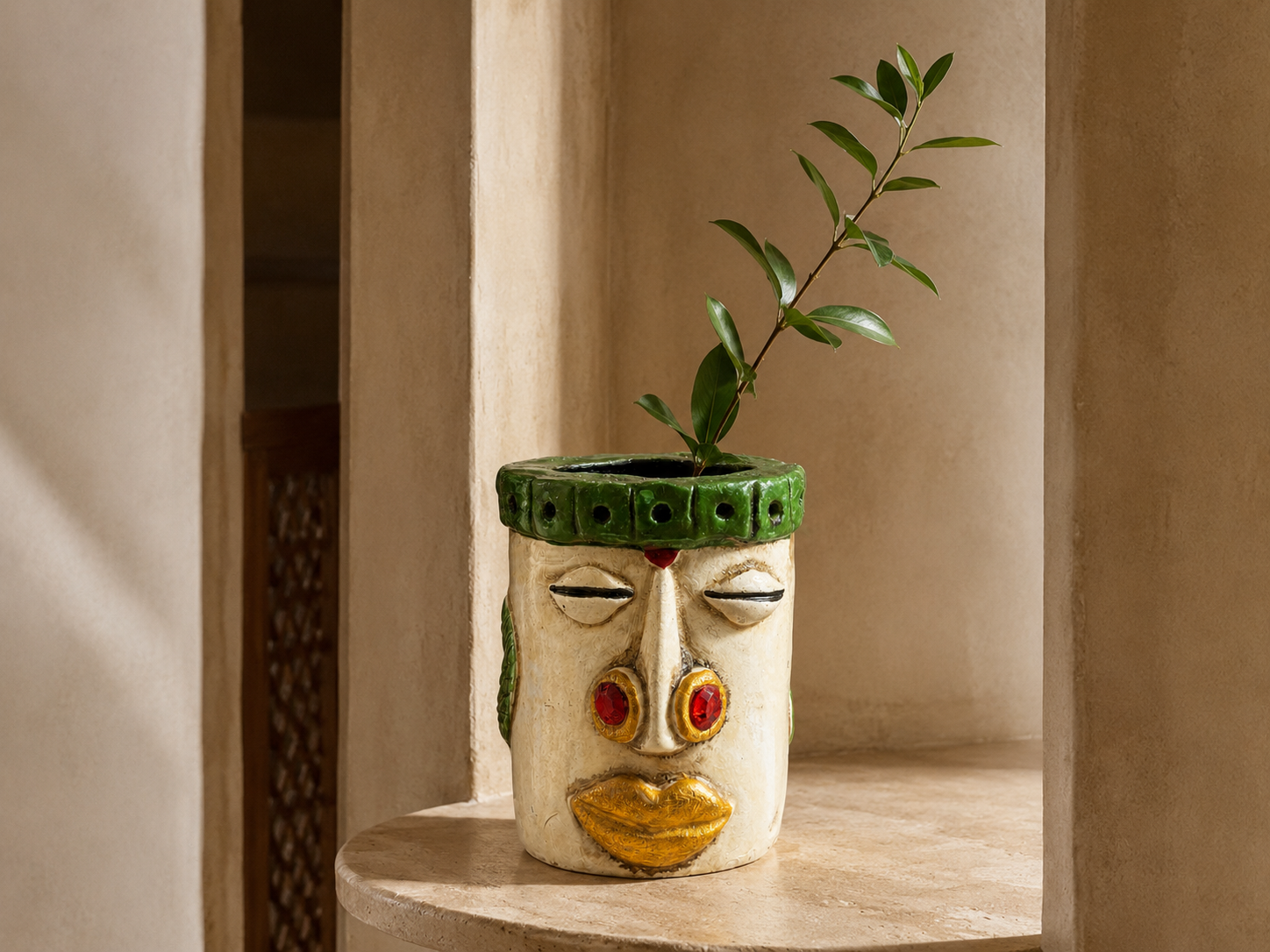 Nomad Bloom ivory and green face holder styled with foliage in a warm interior