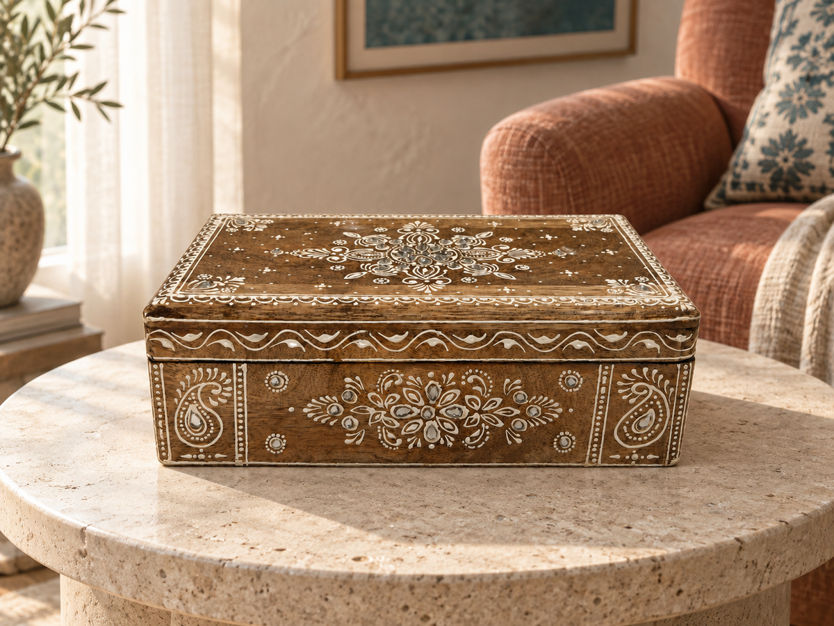 Noor Paisley ivory mirrorwork keepsake box displayed on a round stone table