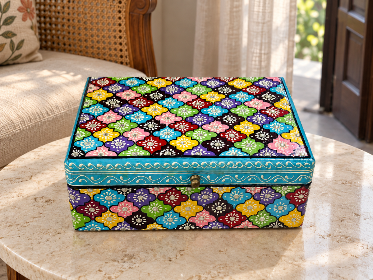Phool Mosaic floral keepsake box displayed on a stone table beside a settee
