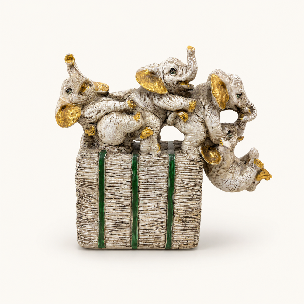 Ivory, gold, and green playful elephant parade sculpture, front view