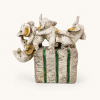 Ivory, gold, and green playful elephant parade sculpture, reverse view