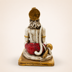 Rear view of the Hanuman idol showing textured hair, long curved tail and red dhoti