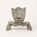 Quiet Reflection silver-toned mosaic face resting on hands sculpture, front view
