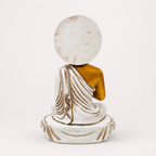 White, gold and red seated Buddha decorative statue, back view