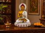 White, gold and red Buddha statue styled in a traditional interior