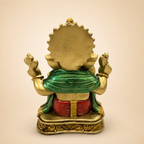 Rear view of the Ganesha idol showing the green shawl, red dhoti and detailed gold-tone base