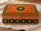 Rang Jyoti orange and black mirrorwork keepsake box displayed on a linen runner
