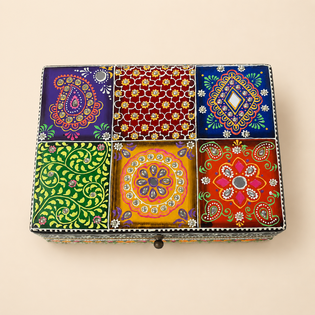 Top view of the Rang Mahal box showing paisley, floral and geometric panels with reflective accents
