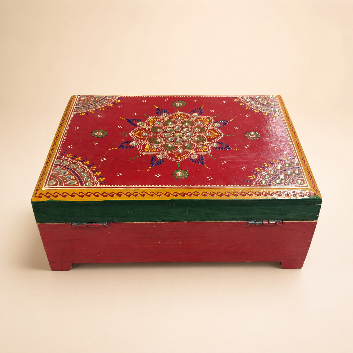 Rear view of the Rang Mahal red keepsake chest showing the patterned lid, green edge and hinges