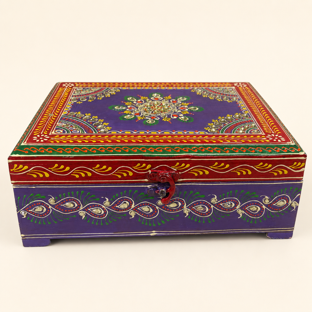 Front view of the Rang Raas purple chest showing the curved clasp, mirror accents and decorative bird and paisley motifs