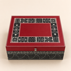 Top view of the red Rang Rekha keepsake box with black and cream patterned border