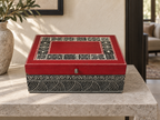 Red and black Rang Rekha keepsake box displayed on a limestone console