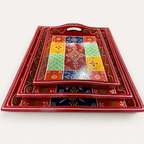 Front view of the Rangoli Bloom floral tray set showing curved rims and cut-out handles