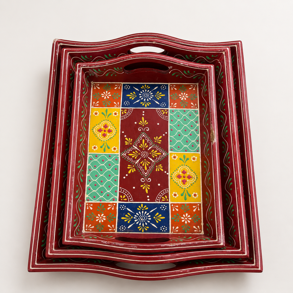 Top view of three red nested trays with colourful floral and geometric patterns