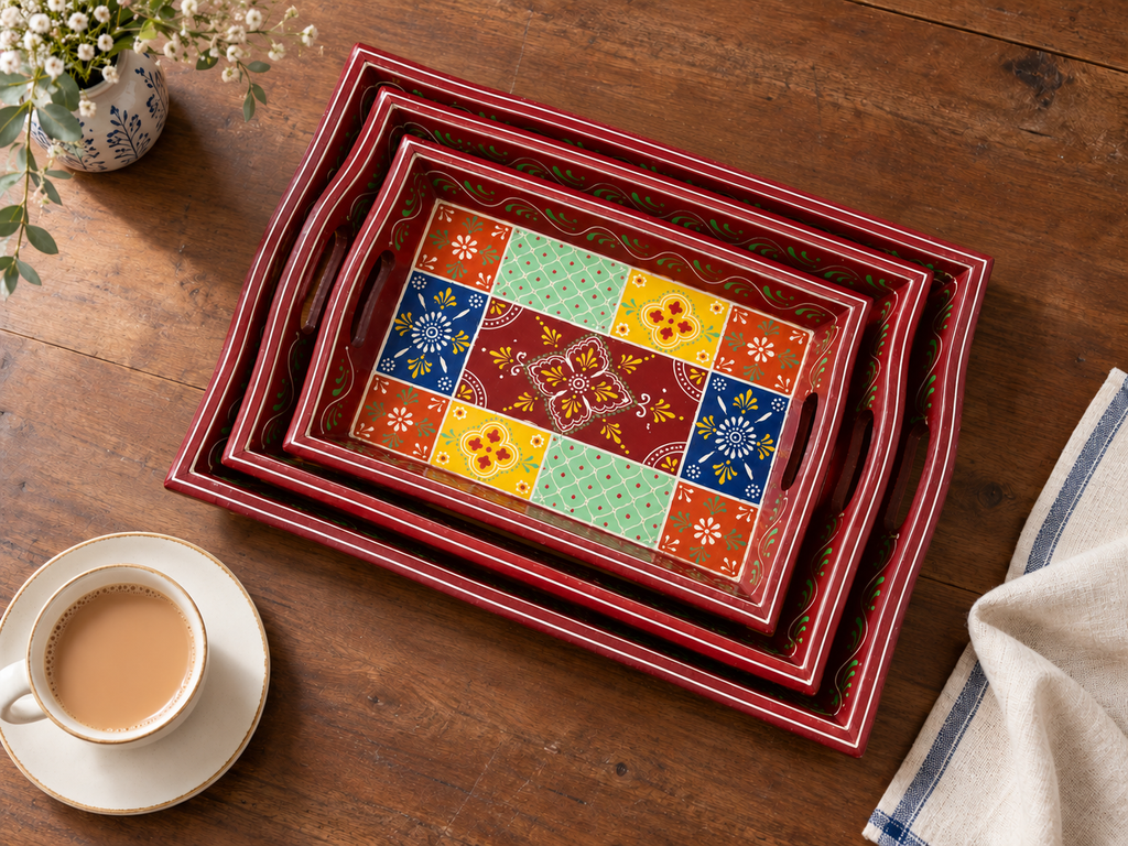 Rangoli Bloom nested trays styled on a wooden tea table
