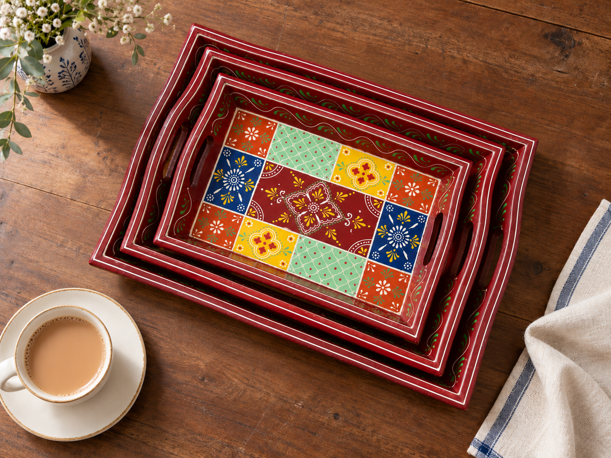 Rangoli Bloom nested trays styled on a wooden tea table